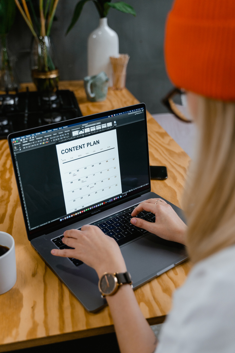 A Woman Making a Content Plan Using a Laptop